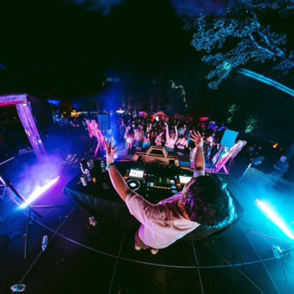 Blue and Purple Lasers with a stage and DJ