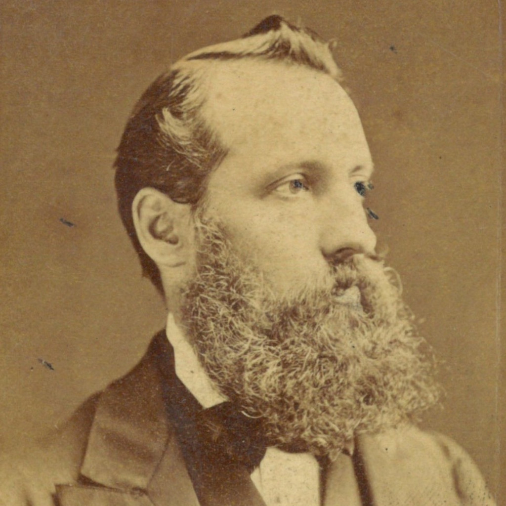A sepia photo of a Victorian gentleman with a bushy beard