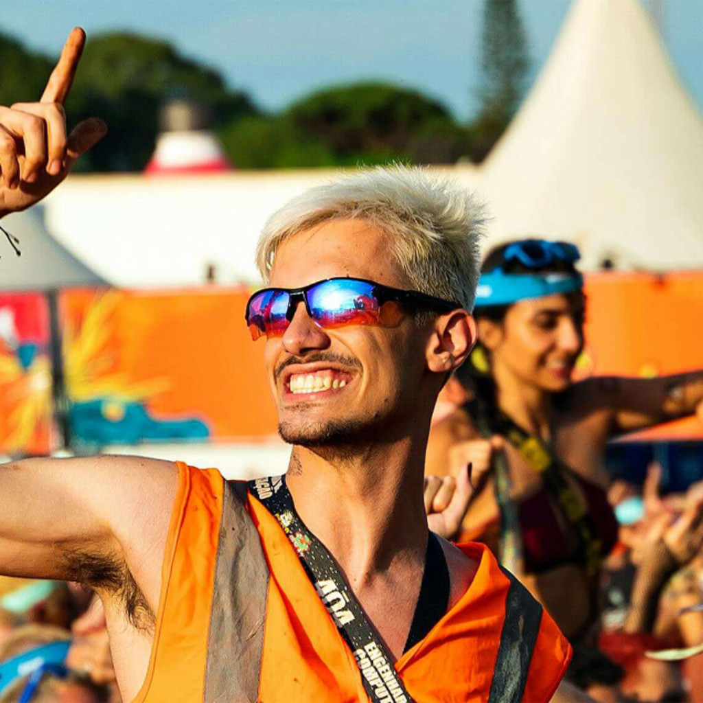 Man smiling in festival crowd