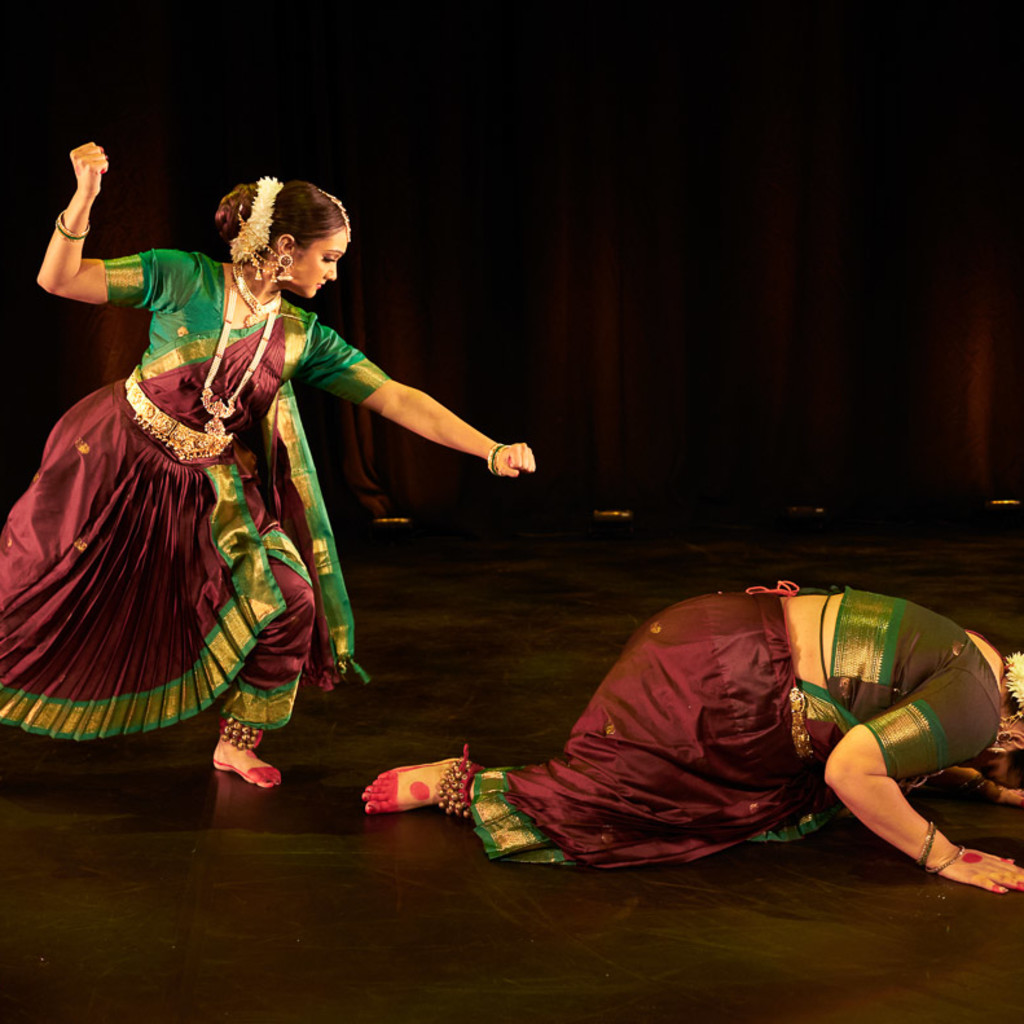 A Bharatanatyam dancer aiming a spear downwards