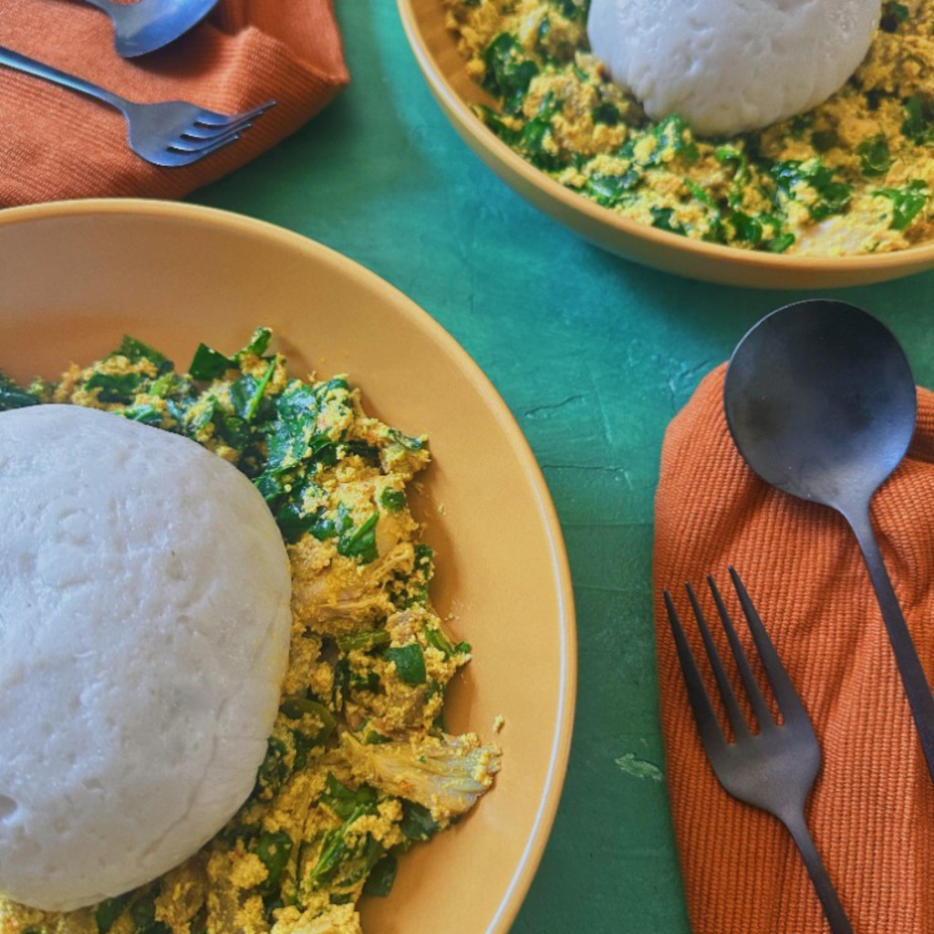 Two bowls of iyan with egusi and efo riro