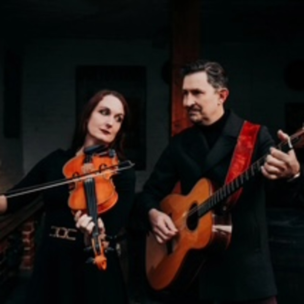 The image features Nancy Kerr with a fiddle on the left and James Fagan with a guitar on the right in front of a black background