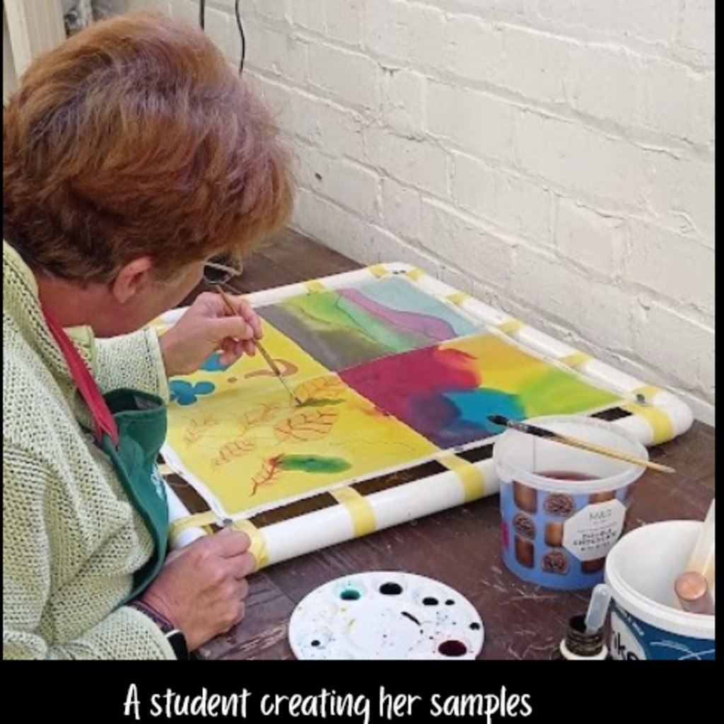 A picture of a student painting samples.