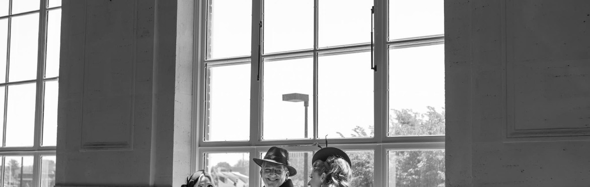 2 women and one man smiling