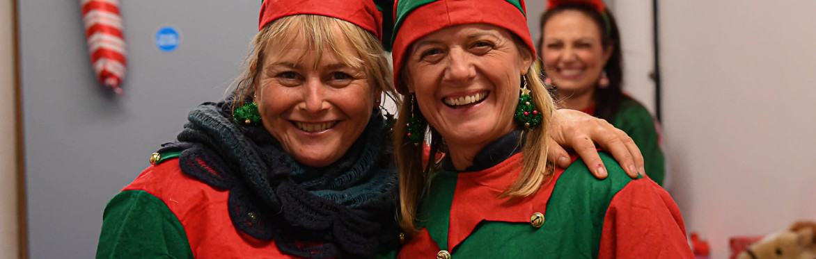 Two women dressed as Christmas elves smiling at the All-Steps Christmas Show