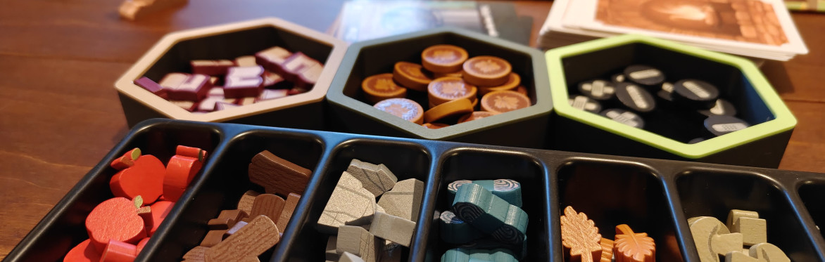 Close up shot of cards and purple wooden turnip tokens on a table from the board game "Village Pillage"
