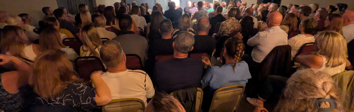 Steve Gribbin, Alistair Barrie and Mick Ferry next to an Off The Rails Comedy Club, Saddleworth logo