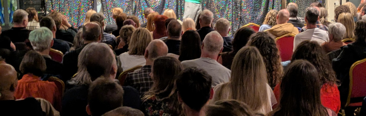 Peter BrJack Gleadow, Larry Dean and Gareth Mutch next to a Didsbury Comedy Club logo