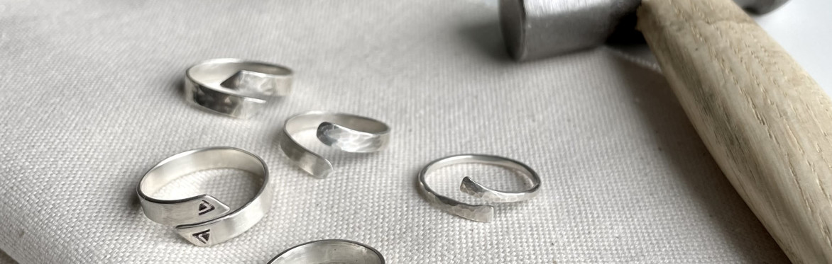 a group of five silver wrap rings