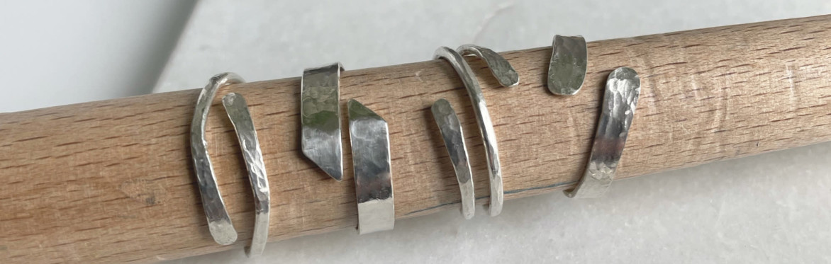 a group of five silver wrap rings