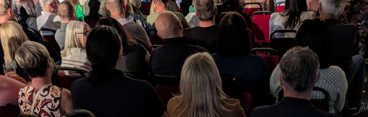 Jack Gleadow, Larry Dean and Scott Bennett next to a Heatons Comedy Club logo