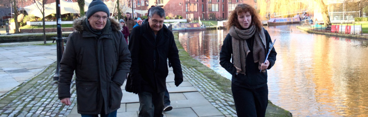 A photograph showing a tour guide talking to a group of people