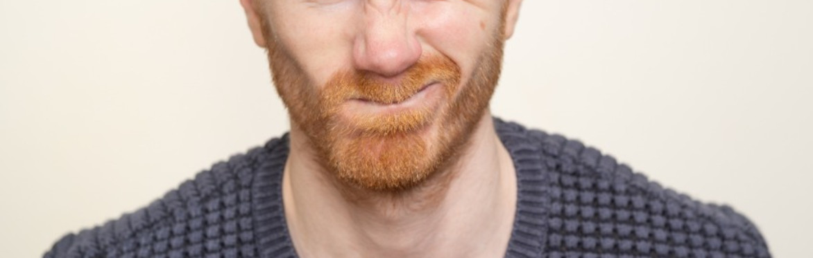 Sam Adamson leaning forward and winking at the camera