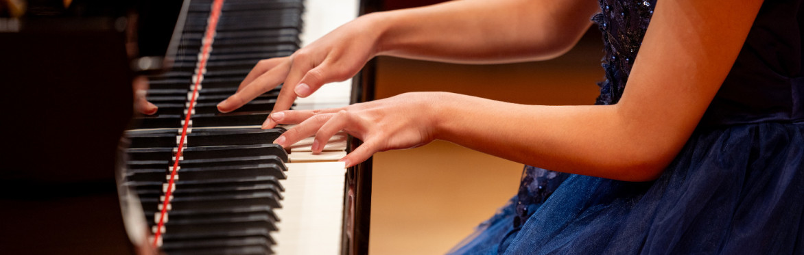a person's hands playing piano