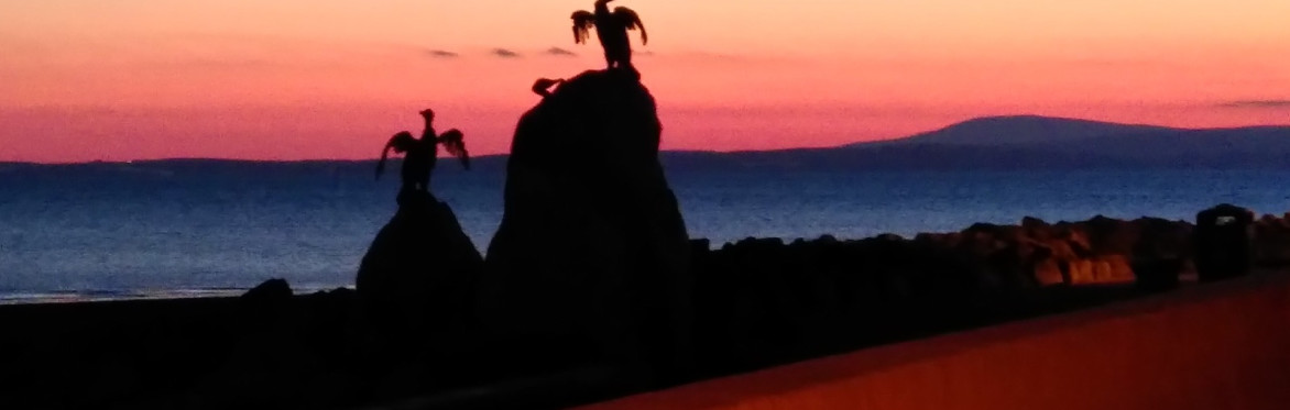 Sunset over Morecambe Bay with Tern Project statues