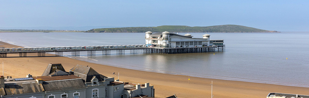 Weston Super Mare. Looking at the Grand Pier, on a sunny day, with Brean Down  in the background