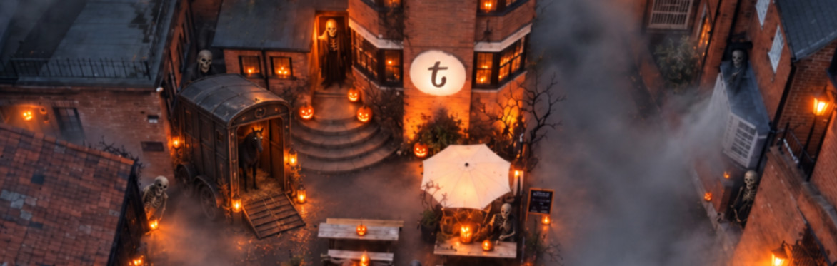 A spooky aerial view of tap.social’s courtyard at night, filled with mist, glowing pumpkins, ghostly figures, skeletons and a mysterious horse box by the entrance steps.