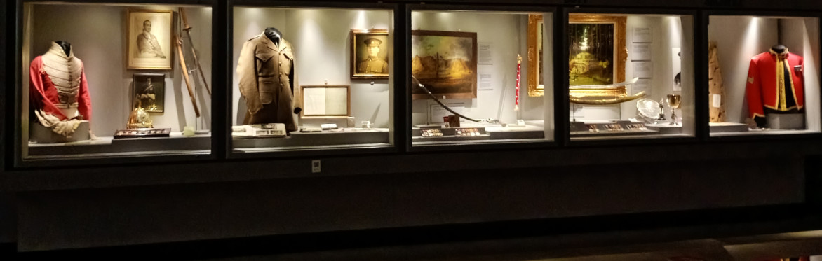 Darkened gallery with a row of 5 display cases lit up