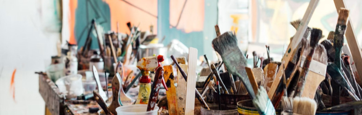 Paint brushes and cans on a table