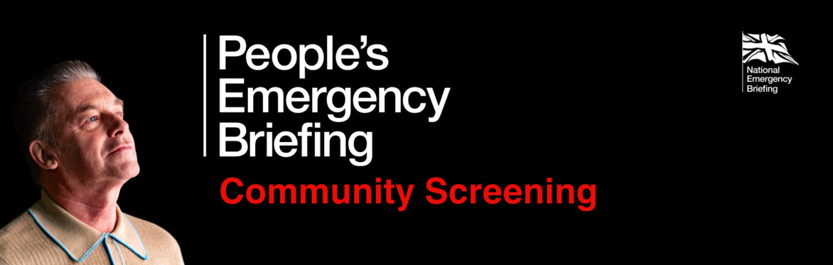 Chris Packham  looks at a sign which reads People's Emergency Briefing Community Screening