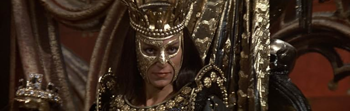 A queen in black and gold glowers at the camera