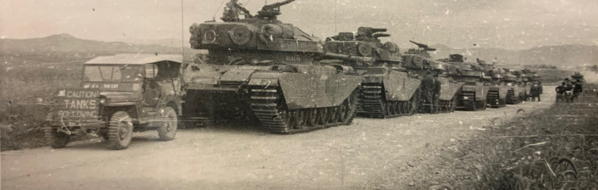 Black and white photograph of a line of tanks