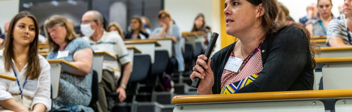 A conference attendee asking a question into a mike