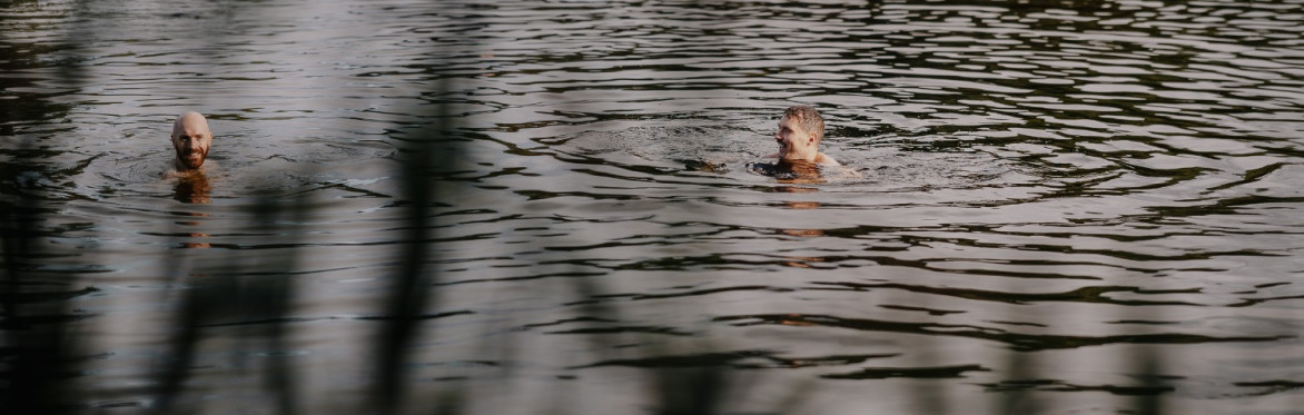 Two people swimming in the Groundless Pool