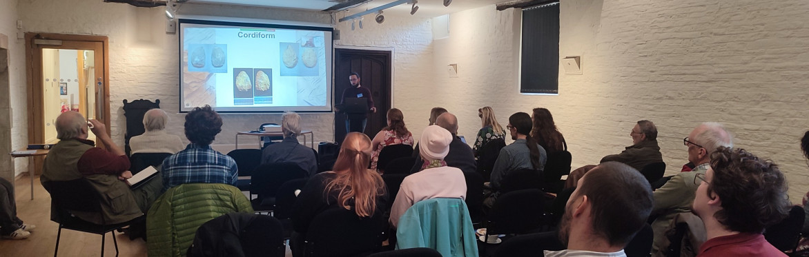 A speaker presenting about handaxes at the LSS 2024 Conference