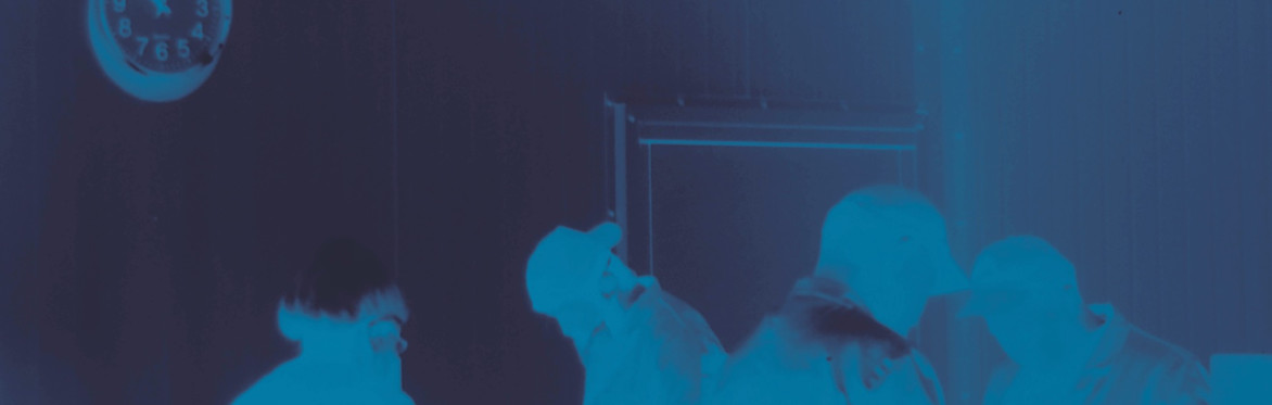 Film still. Rehana Zaman, 2025. people dancing in a blue toned photo