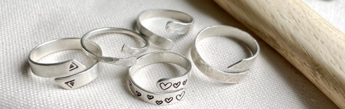 a group of five silver wrap rings