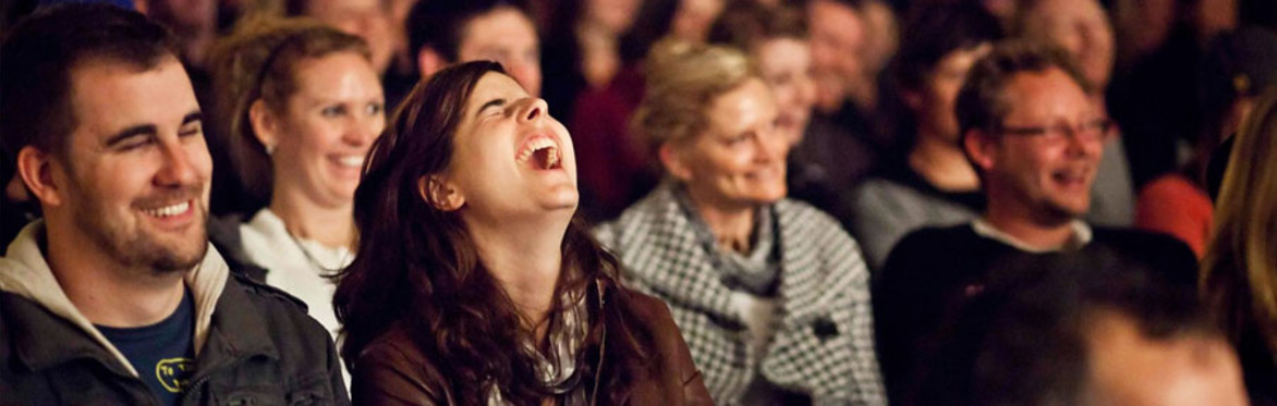 an audience laughing