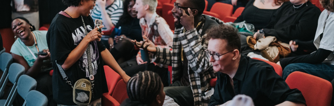 Loads of queer filmmakers networking in a cinema space.