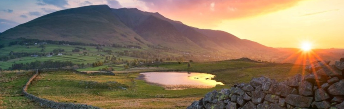 Beautiful image of sunset on a waterbody with a mountain behind