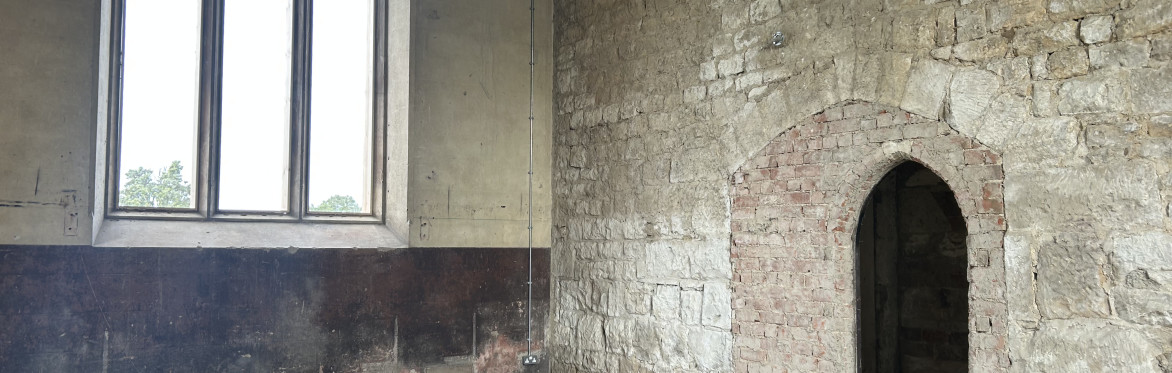 Inside the Chapels of Rest - a vaulted window and arched entrance into a dark side chapel