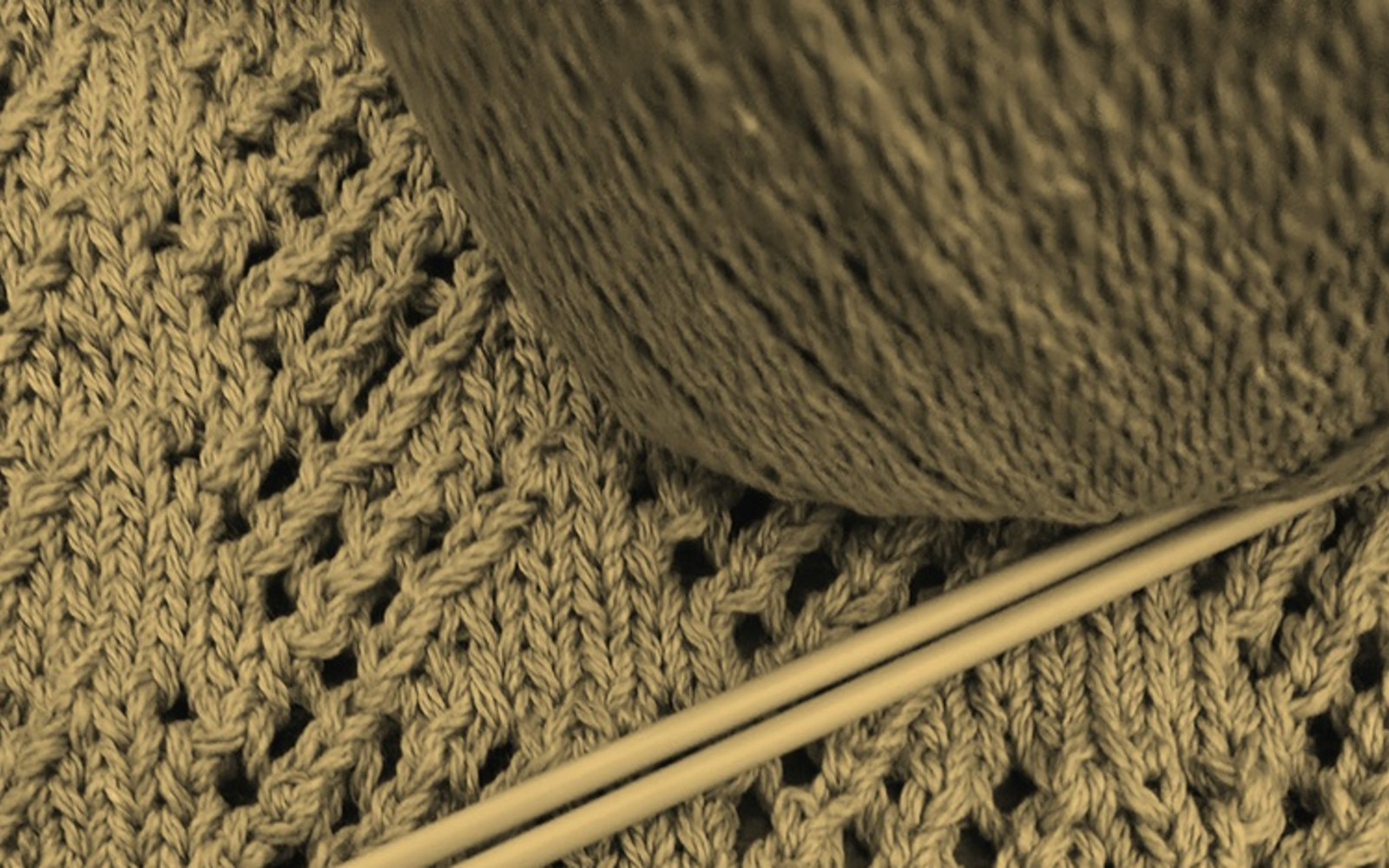 Example of Victorian lace knitting, with ball of yarn and thin knitting needles (in sepia)