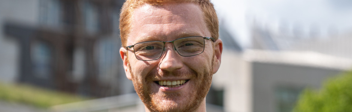 Ross Greer MSP in front of the Scottish Parliamen (credit: Scottish Greens)