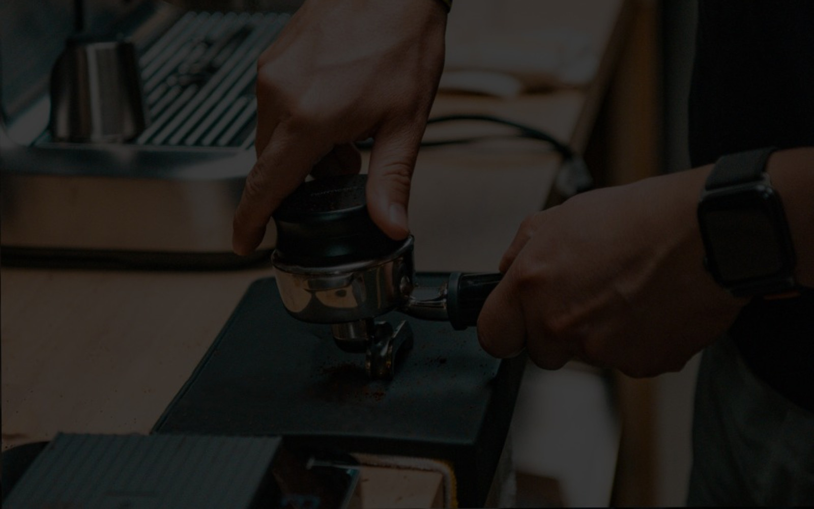 Tamping a portafilter to make espresso