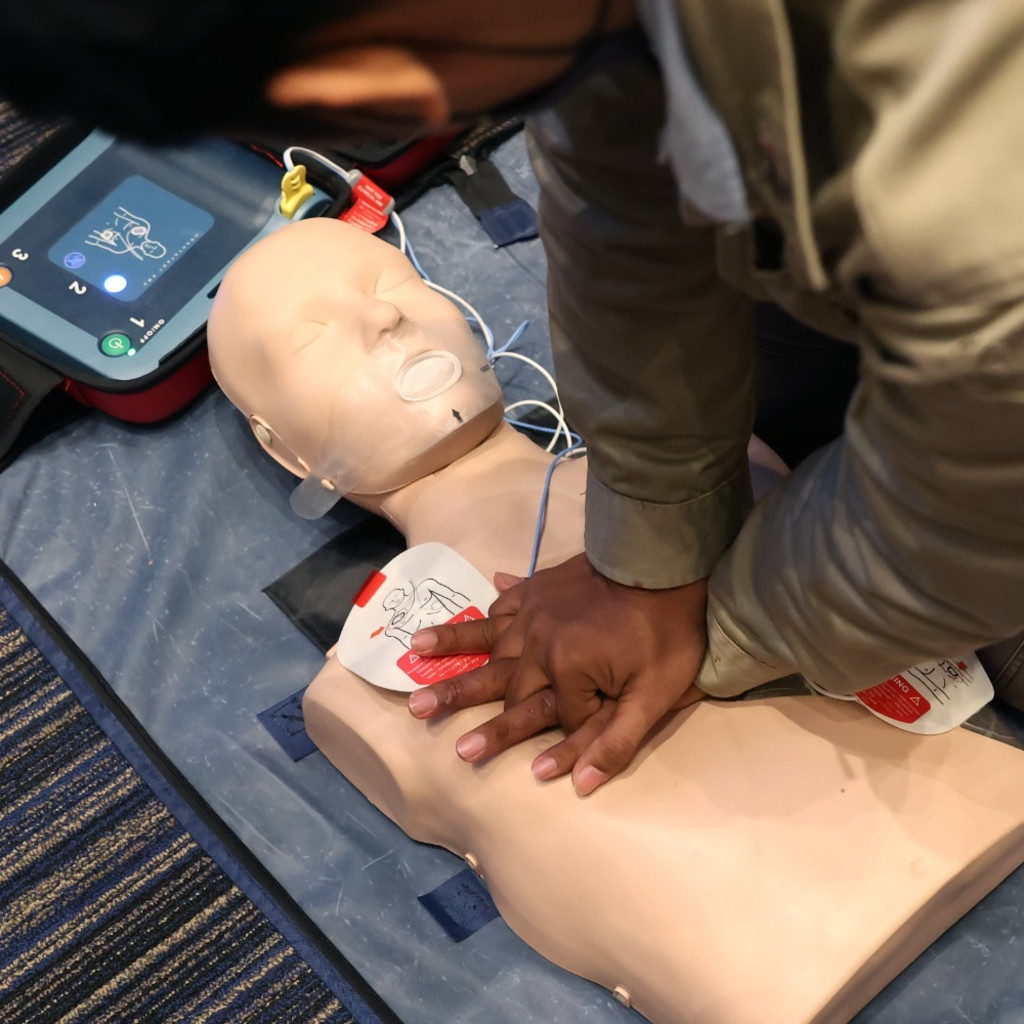 Man practicing CPR on a manikin