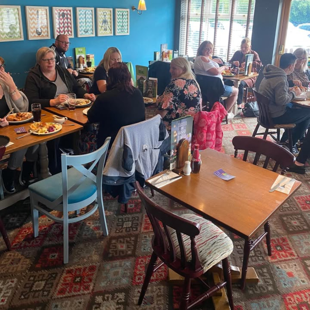 People sat having lunch smiling