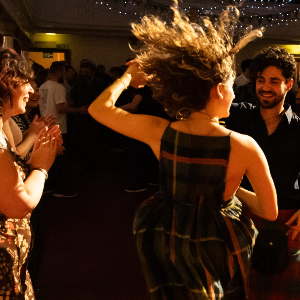 dancers with wild hair, big smiles, and lovely beards