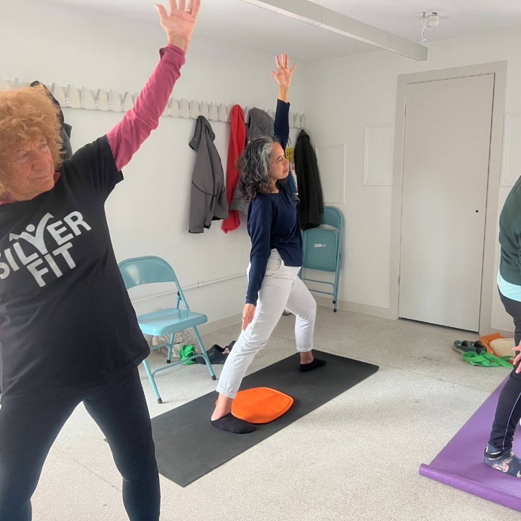 people sitting on floor in yoga pose