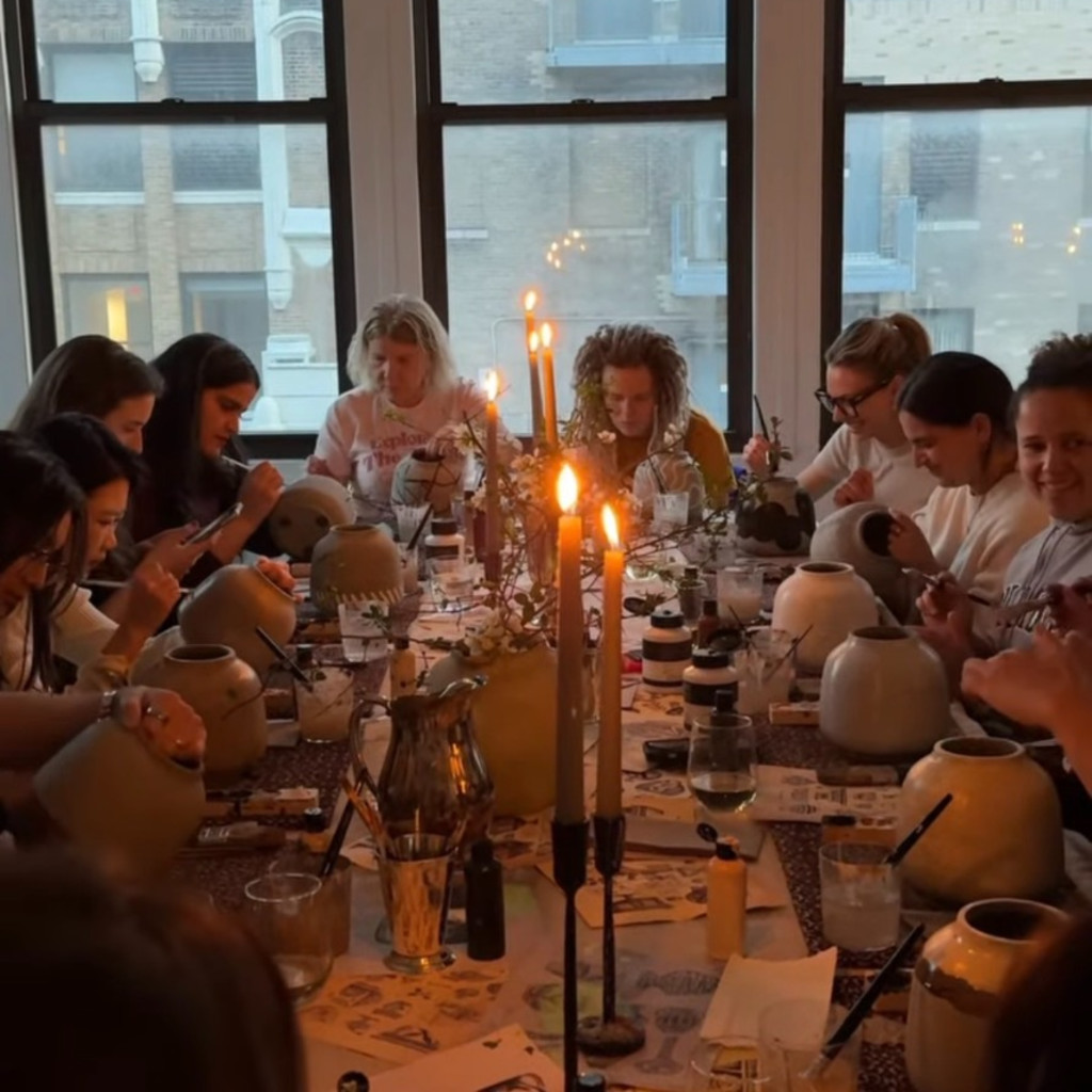 people painting vases with acrylic