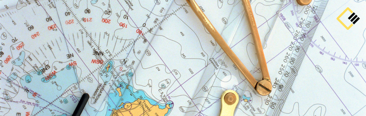 Nautical chart with contour lines and coastal details, overlaid with a pair of brass dividers and a ruler. The image conveys navigation and exploration.