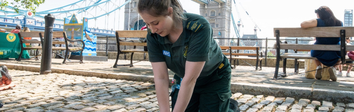 A photo of two people performing CPR and operating a defibrillator