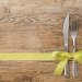 knife and fork tied with a gift ribbon
