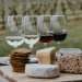 A cheeseboard and some glasses of wine