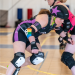A2 Roller derby jammer skating around her opponent.