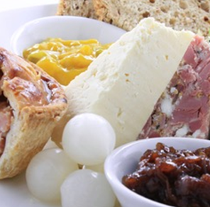 Locally sourced cheeses, thick-cut ham, homemade pork pie.  Chutney, pickles, crisp onions, fresh apple, celery,  crusty roll with butter.  Includes your choice of tea, coffee