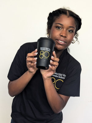 Student holding travel mug